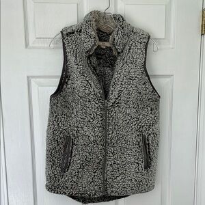 Cozy gray Sherpa vest with zippered front pockets.